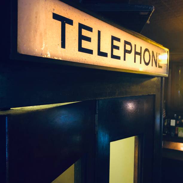 vintage illuminated telephone booth sign - 1930s style telephone 1940s style old stock-fotos und bilder