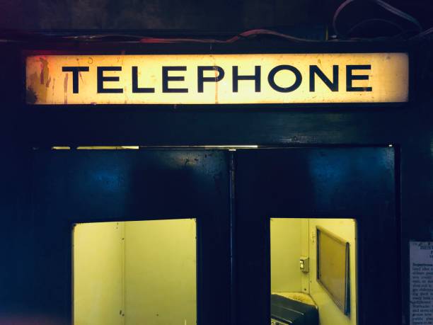vintage illuminated telephone booth sign - 1930s style telephone 1940s style old stock-fotos und bilder