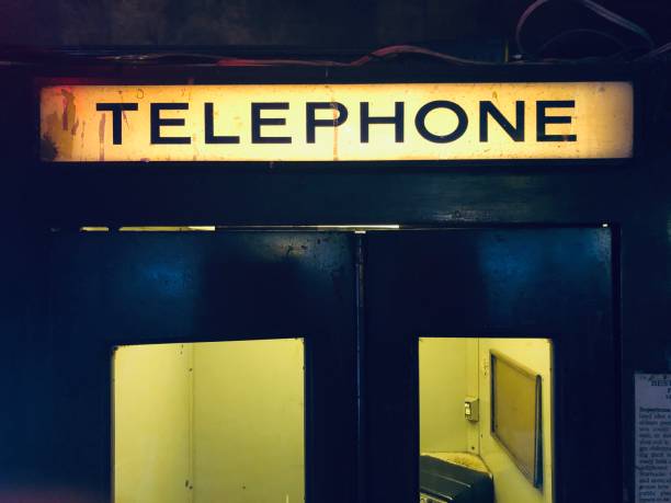 vintage illuminated  telephone booth sign - coin operated pay phone telephone communication imagens e fotografias de stock