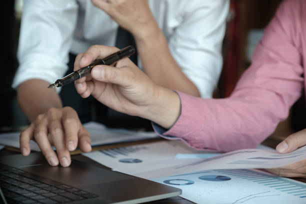 istock Economic research discussions, Business team analyzing income charts and graphs to plan marketing concept with using laptop computer and pen for analysis. 1135010085