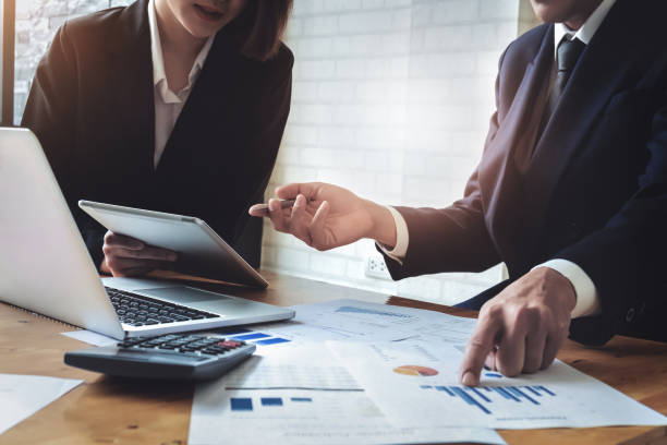 istock Economic research discussions, Business team analyzing income charts and graphs to plan marketing concept with using tablet and calculator  for analysis. 1135011246