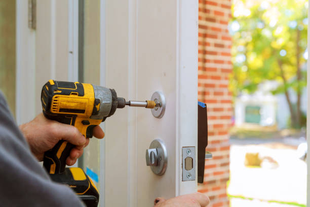 man repairing the doorknob. closeup of worker's hands installing new door locker worker's hands installing new door locker man repairing the doorknob. closeup door repairman men manual worker stock pictures, royalty-free photos & images