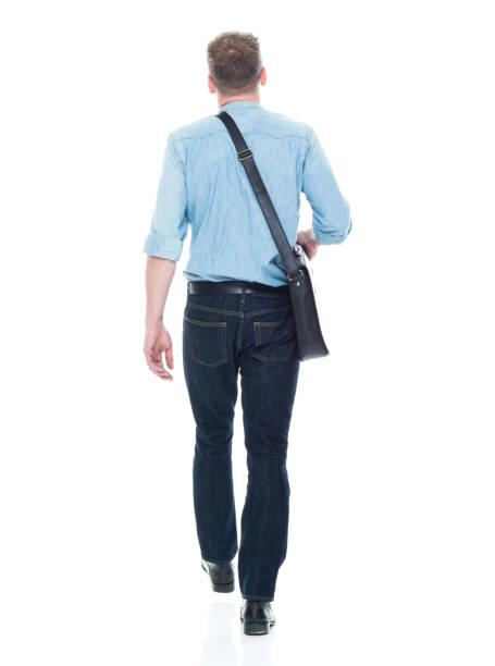 istock Rear view of man walking with a shoulder bag 1135019971