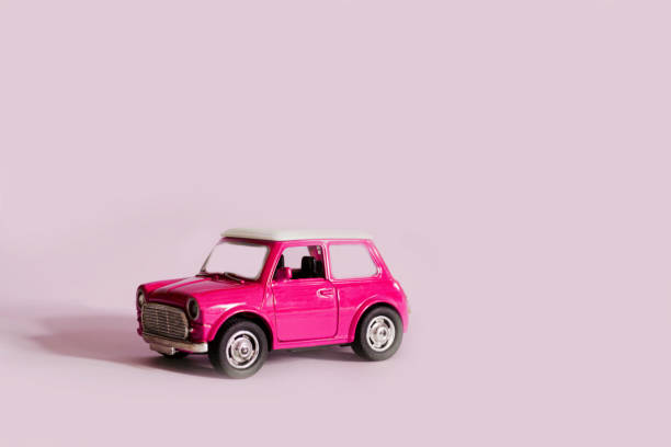 istock bright pink retro car on a light pink background 1135023385
