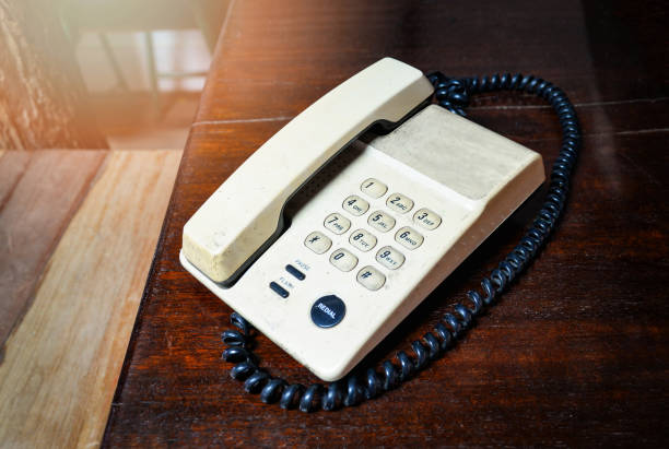 istock Retro telephone old on wooden table in office ancient tone style 1135024175