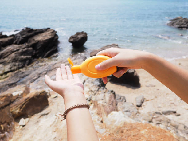 istock hand holding sunblock cream bottle 1135024247