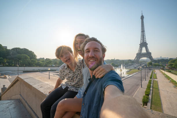 istock Three young adults friends taking selfie in Paris city using mobile phone 1135024433