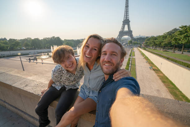 istock Three young adults friends taking selfie in Paris city using mobile phone 1135024457