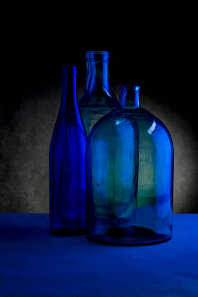istock Still life with three glass bottles on a dark background 1135025354