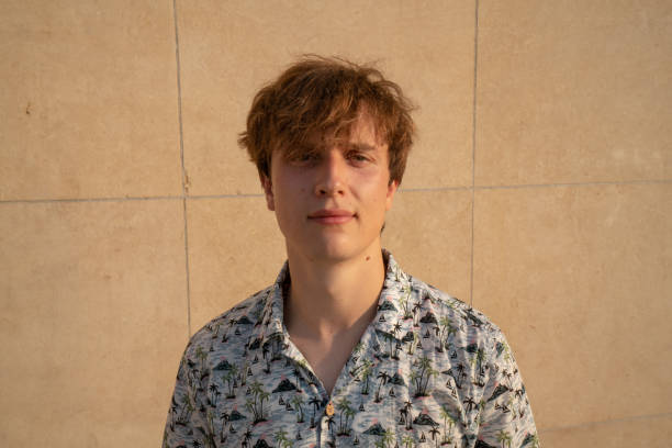 istock Portrait of young man against wall 1135027501
