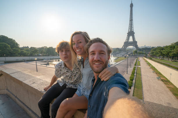 istock Three young adults friends taking selfie in Paris city using mobile phone 1135028476