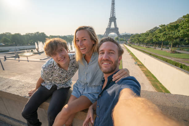 istock Three young adults friends taking selfie in Paris city using mobile phone 1135029134