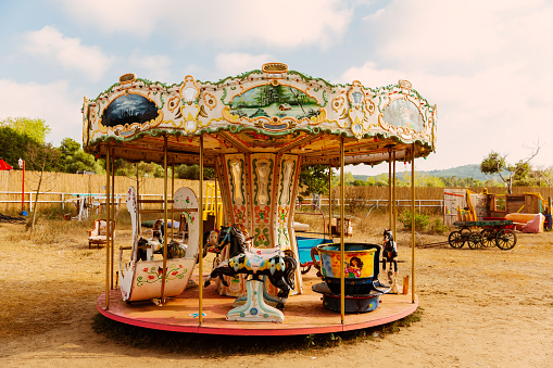 Colorful carousel standing on soil land, looking like abandoned.