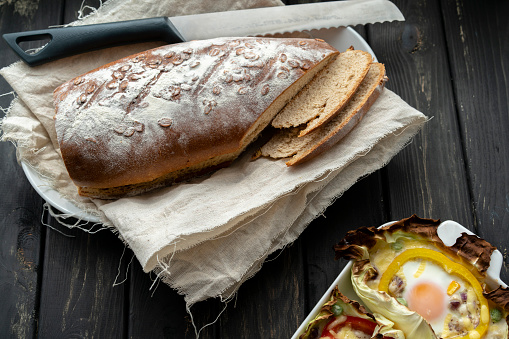 healthy breakfast: homemade bread and baked egg in cabbage leaf