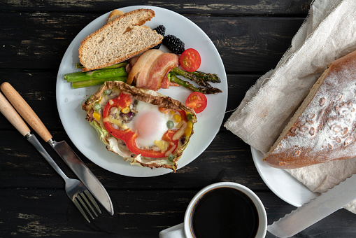healthy breakfast: homemade bread and baked egg,bacon and vegetables