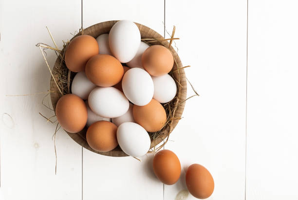 яйца в контейнере для коробок на белом деревянном столе. вид сверху - dozen eggs food eggs horizontal стоковые фото и изображения