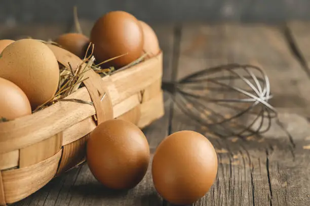 Fresh brown eggs on a wooden table