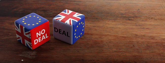 Brexit, deal or no deal concept. United Kingdom and European Union flags on dice, wooden background, banner, copy space. 3d illustration