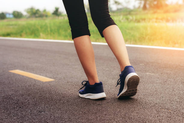 istock Girl is jogging on road. 1135033958
