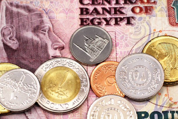 An assortment of Egyptian coins on an Egyptian ten pound note stock photo