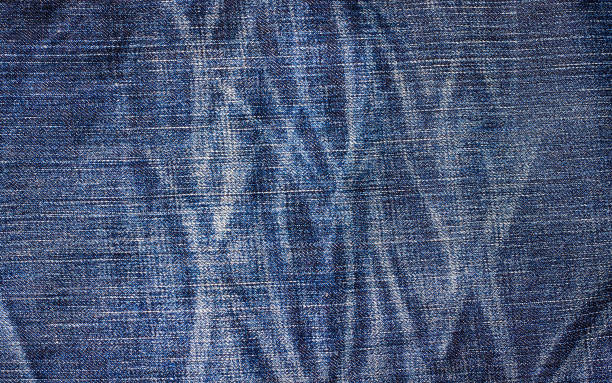 istock Denim blue jeans texture with space for text,  Indigo plain surface, Indigo classic vintage, Close-up of details of a pair of jeans trousers, Fabric Background 1135035036