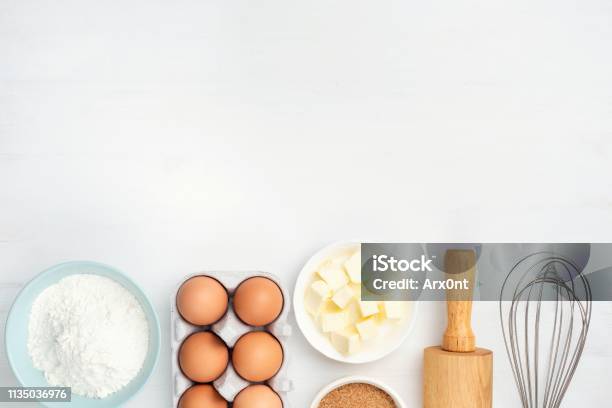 Baking Ingredients And Kitchen Utensils On White Background Stock Photo - Download Image Now