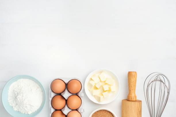 baking ingredients and kitchen utensils on white background - equipment egg beater household equipment kitchen utensil imagens e fotografias de stock