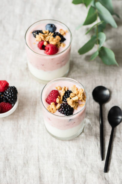 istock Yogurt with berries and granola in glass cup 1135037006