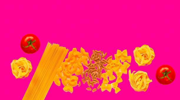 istock Various uncooked pasta on pink background. Food concept. 1135037045