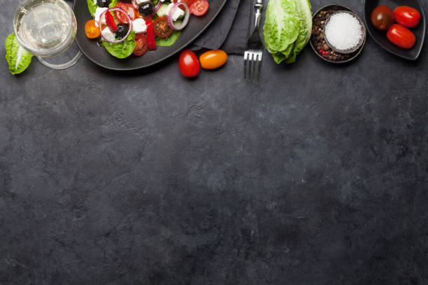 istock Greek salad plate and white wine 1135037489