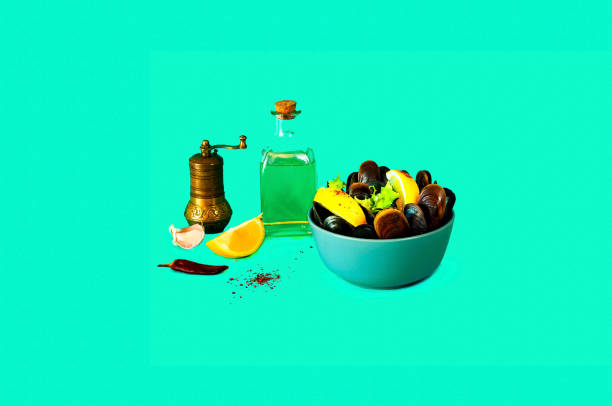 istock Mussel shells in blue bowl and olive oil on blue backgroud. 1135038230