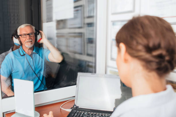 senior patient having hearing exam in special audio room Senior man getting a hearing test at a doctors office, audiometer hearing test hearing test stock pictures, royalty-free photos & images