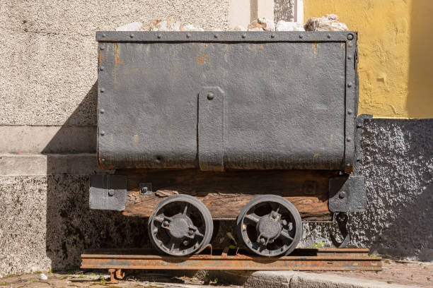 Close-up of an old mining cart with wheels on rail for the transportation of minerals. Friuli, Italy, Europe