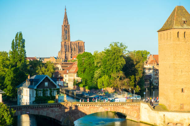 Far Cathedral Bridges covered River Strasbourg H Distant Cathedral of Our Lady behind Ill River Ponts Couverts and defensive tower of Strasbourg, France notre dame de strasbourg stock pictures, royalty-free photos & images