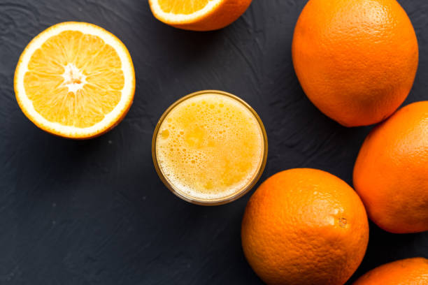 istock Fresh juicy oranges on wooden table 1135045555