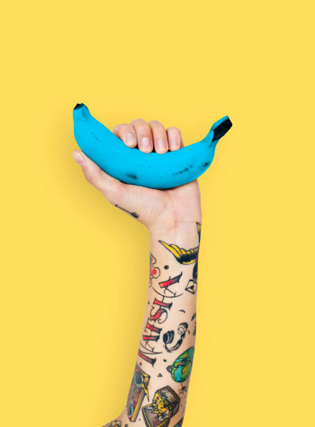 Hand with a blue banana Banana overlay word young people tattoo arm stock pictures, royalty-free photos & images