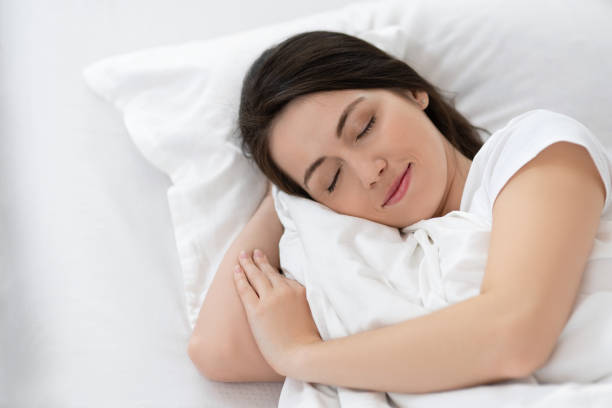 istock girl sleeping on white bed 1135047718