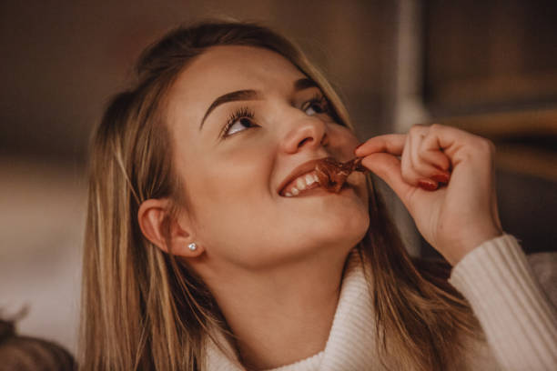 istock Young woman eating appetizer 1135047815