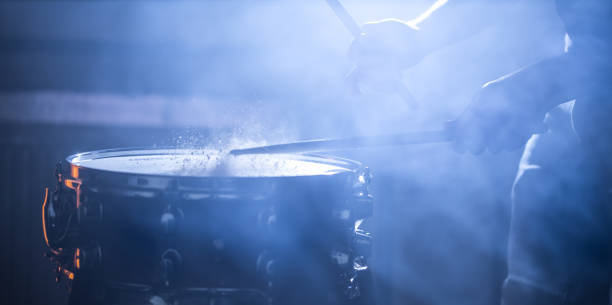 istock man playing the snare drum on a beautiful colored background 1135051325