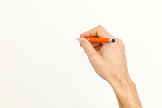 istock writing hand. male hand hold black pen write on the wall isolated on white with clipping path 1135054443
