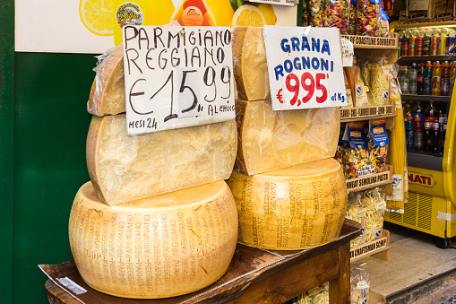 Naples, Italy - 21st September 2017: Rounds of cheeses for sale outside a shop. Parmesan cheese is known the world over.