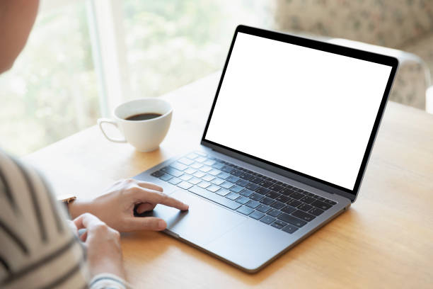 istock Women using laptop with blank screen at table in the office. 1135056890