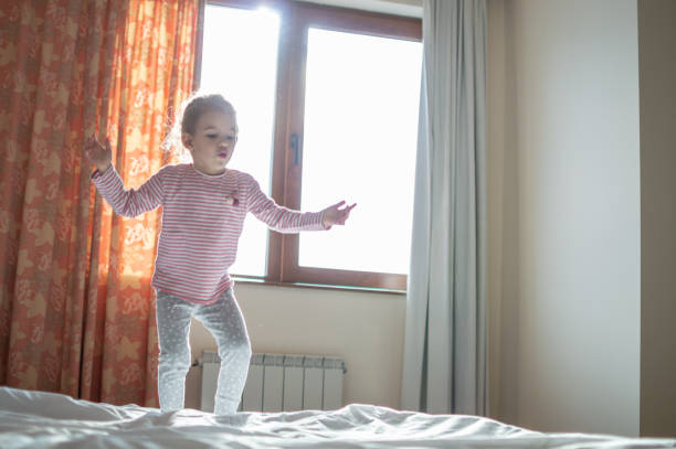 istock Beautiful girl jumping on the bed 1135057720