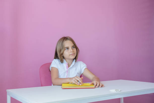 Child studying and researching on laptop and notebook