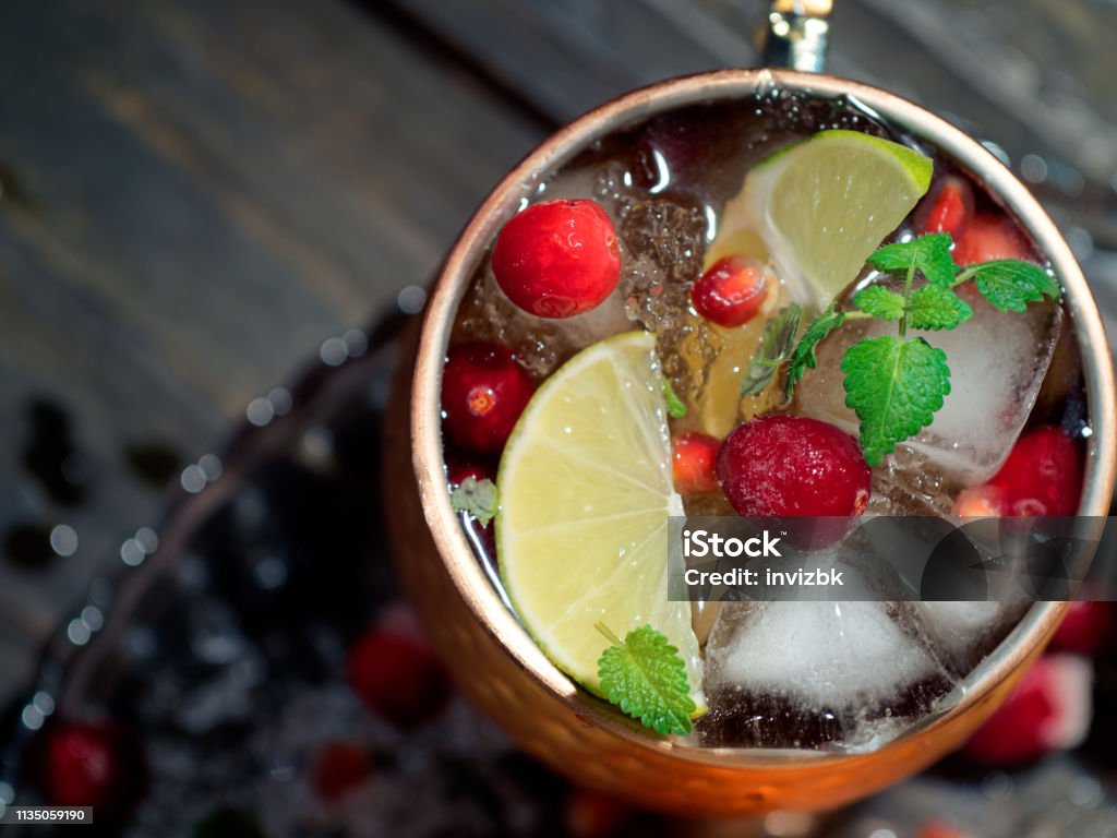 Cranberry pomegranate Moscow mule Homemade cranberry pomegranate Moscow mule served in copper mugs Moscow Mule Stock Photo