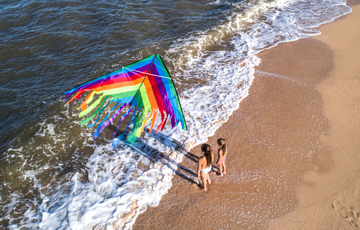 Girl play with kite at seashore