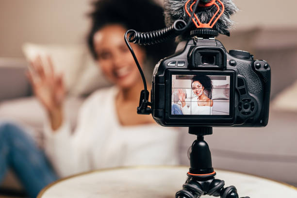 Vlogger recording content for her blog on a DSLR camera stock photo