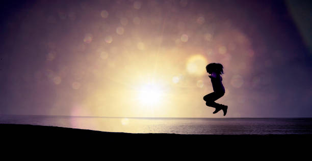 istock Woman Jumping over the Beach 1135060193