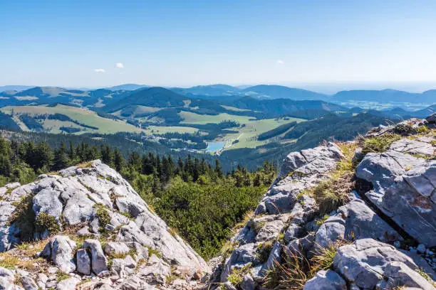 View from summit of mountain Hochlantsch to lake Teichalmsee to alps Teichalm and Sommeralm in Styria, Austria