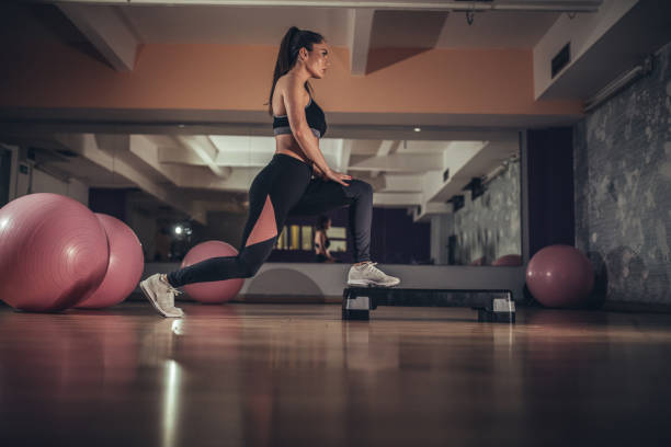 istock Beautiful woman exercising in gym 1135062724